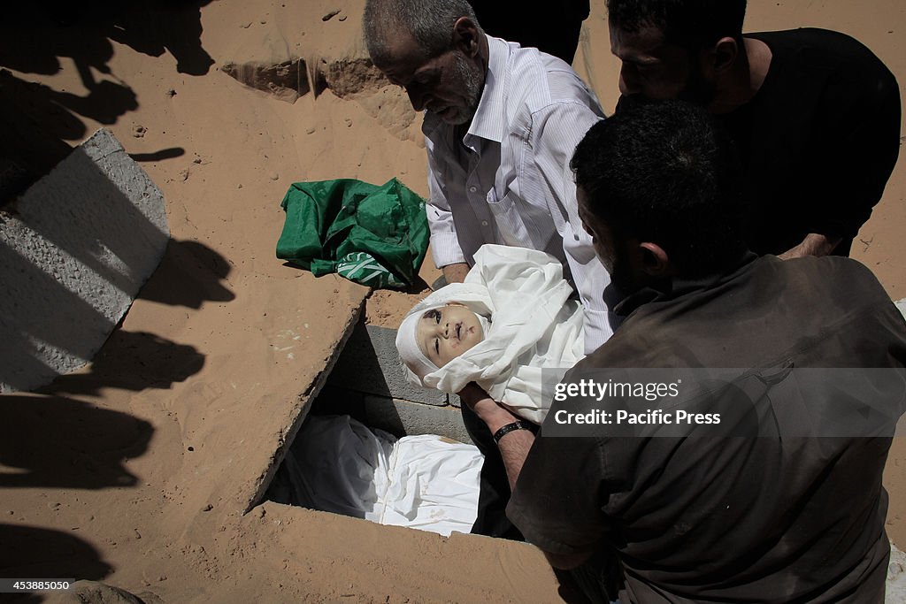 Palestinians during the burial of the infant son of Mohammed...