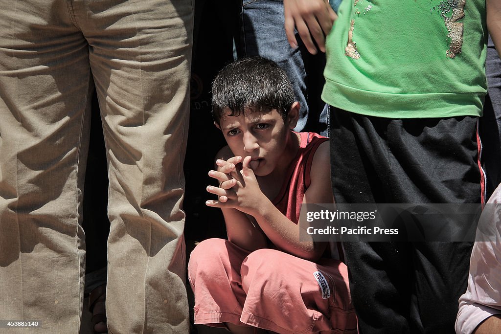 Palestinian child showing feeling of remorse during burial...