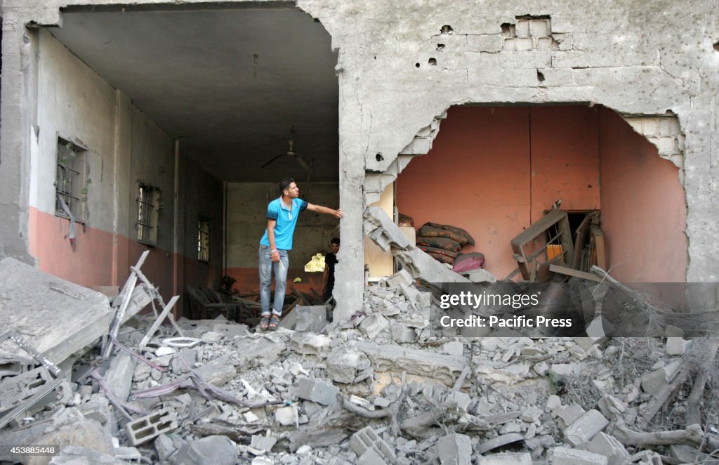 Palestinian stands  in his destroyed house  hit by an...