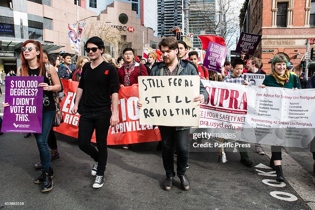 Students march holding  banners, signs and flags at a Sydney...