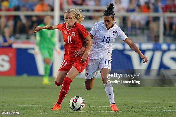 Lara Dickenmann of the Swiss women's national team and Carli Lloyd of the U.S. Women's national team compete for the ball during their match at...