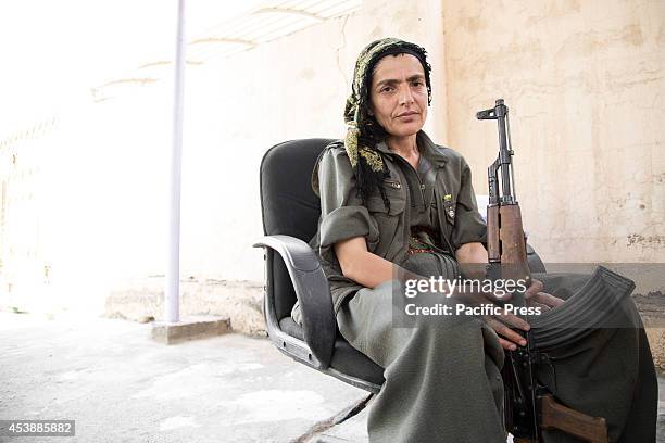 Nugeen, 45 is a PKK fighter who took part in the recent battle for Makhmour. She is seen siting in a chair at the PKK base in Makhmour. Makhmour is a...