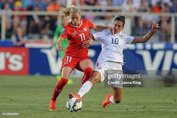 Lara Dickenmann of the Swiss women's national team and Carli Lloyd of the U.S. Women's national team compete for the ball during their match at...