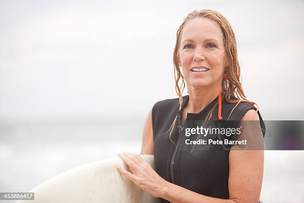 50's women surfer day at the beach - older woman wet hair stock pictures, royalty-free photos & images