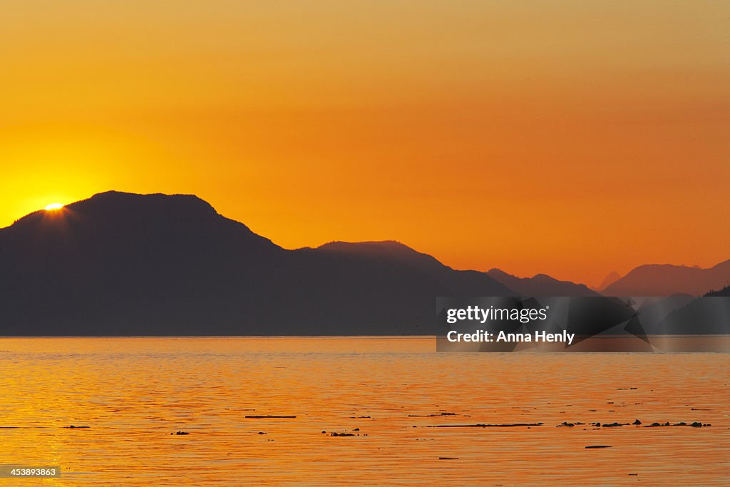 Sunset or sunrise over coastal scene seascape