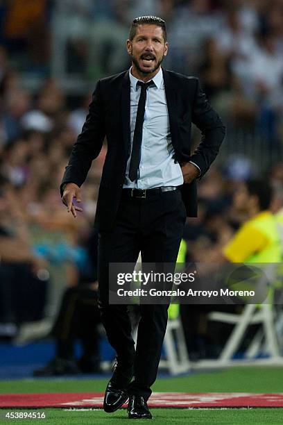 Head coach Diego Pablo Simeone of Atletico de Madrid gives instructions during the Supercopa first leg match between Real Madrid and Club Atletico de...
