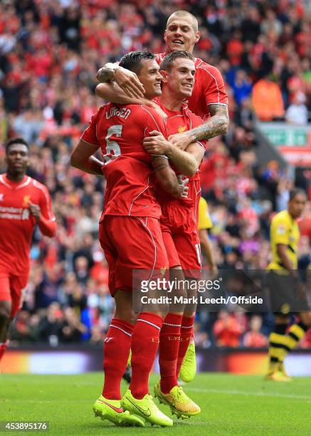 Dejan Lovren of Liverpool celebrates with teammates Jordan Henderson and Martin Skrtel after scoring their 2nd goal during the pre-season friendly...