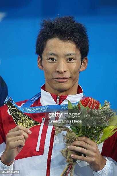 Ryosuke Irie of Japan holds the gold medal after winning the Men's 100m Backstroke final during day one of the 2014 Pan Pacific Championships at Gold...