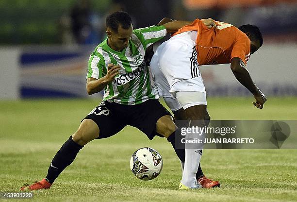 Venezuela's La Guaria player Oscar Gonzalez vies for the ball with Colombia's Nacional player Alejandro Guerra during their Copa Sudamericana...
