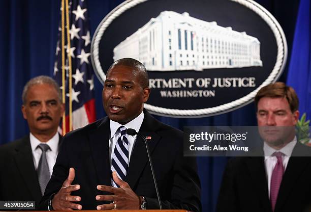 Associate Attorney General Tony West speaks as Attorney General Eric Holder and Kentucky Attorney General Jack Conway listen during a major financial...