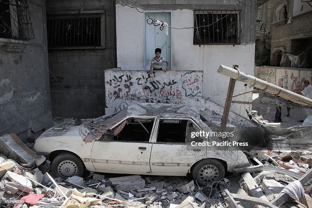 A Local resident sits within the rubble of a destroyed...