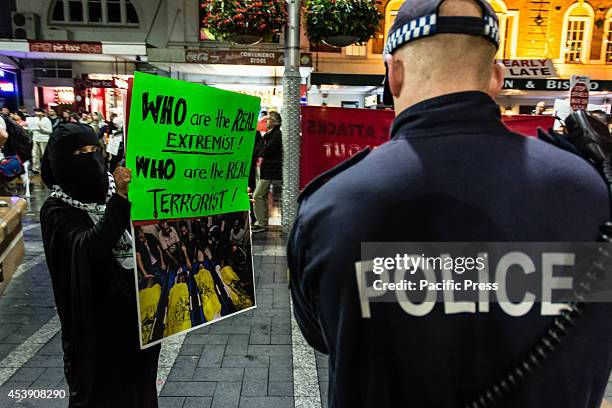Woman wearing a burka parades in front of the NSW police holding a banners with dead Palestine children at a Pro-Palestine protest against the...