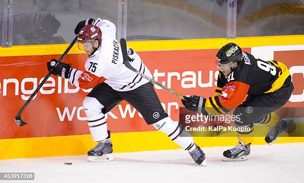 Janne KerÃ¤nen is trying to get the puck back from Jan Piscacek during the Champions Hockey League game between KalPa Kuopio and Sparta Prague at...