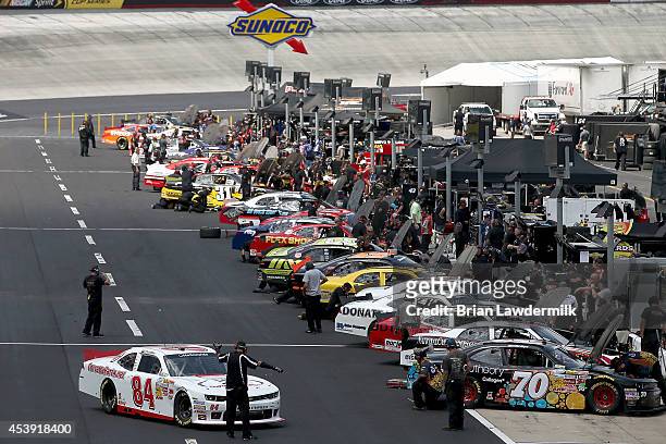 Cars enter the garage area during practice for the NASCAR Nationwide Series Food City 300 at Bristol Motor Speedway on August 21, 2014 in Bristol,...