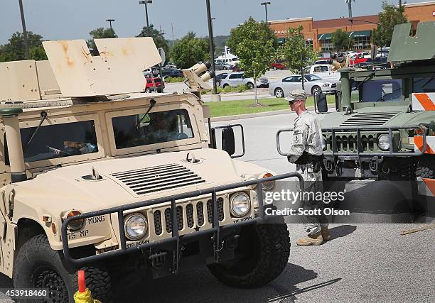 Military police, with the Missouri Army National Guard, stand guard at the police command center which was established to direct security operations...