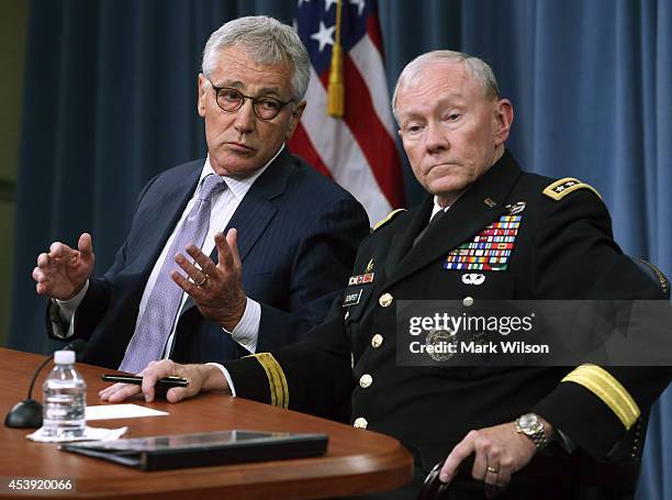 Secretary of Defense Chuck Hagel and Chairman of the Joint Chiefs of Staff General Martin Dempsey speak to the media during a press briefing at the...