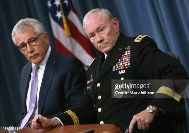Secretary of Defense Chuck Hagel and Chairman of the Joint Chiefs of Staff General Martin Dempsey speak to the media during a press briefing at the...