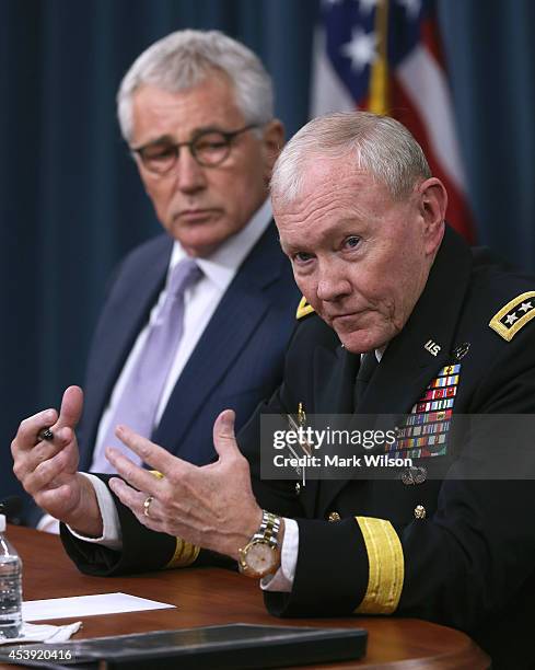 Secretary of Defense Chuck Hagel and Chairman of the Joint Chiefs of Staff General Martin Dempsey speak to the media during a press briefing at the...