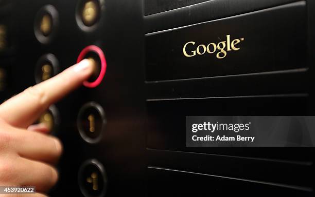 Visitor pushes a button in the Google offices' elevator on August 21, 2014 in Berlin, Germany. Google reported last month nearly $16 billion in...