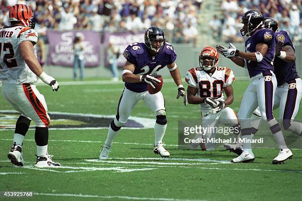Cornerback Rod Woodson of the Baltimore Ravens breaks through the line for a few extra key yards during a NFL game against the Cincinnati Bengals at...