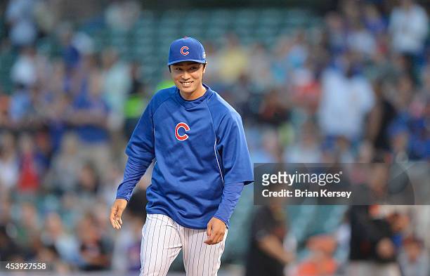 Starting pitcher Tsuyoshi Wada of the Chicago Cubs smiles after defeating the San Francisco Giants in a resumed game at Wrigley Field on August 21,...