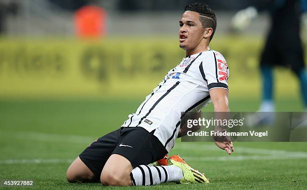 Luciano of Corinthians celebrates scoring the fourth goal during the match between Corinthians and Goias for the Brazilian Series A 2014 at Arena...