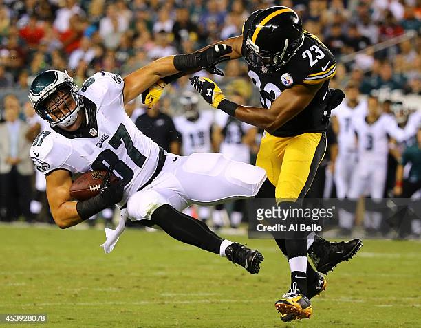 Tight end Brent Celek of the Philadelphia Eagles makes a catch and is hit by safety Mike Mitchell of the Pittsburgh Steelers on August 21, 2014 at...