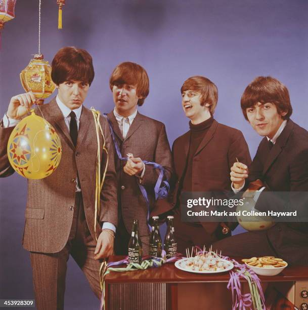 1st OCTOBER: The Beatles posed with bottles of beer and party snacks and balloons in October 1964. Left to right: Paul McCartney, John Lennon , Ringo...