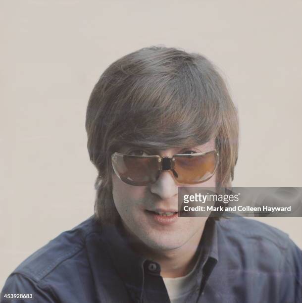 1st JANUARY: Posed studio session of John Lennon from The Beatles, wearing sunglasses in 1965.
