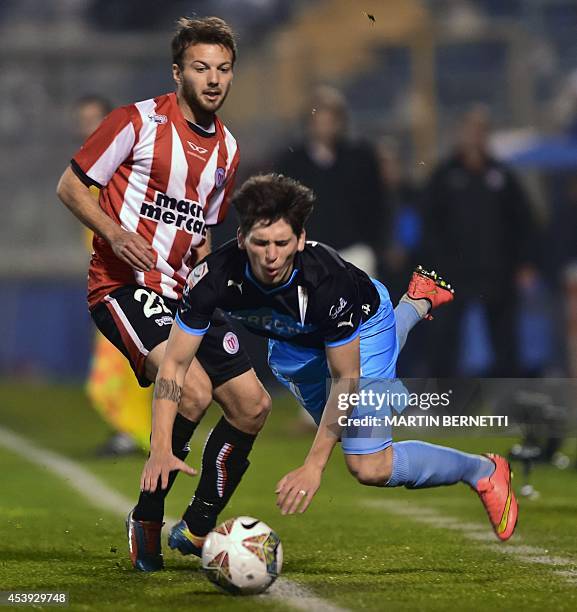Chile's Universidad Catolica's player Alfonso Parot vies for the ball with Uruguay's River Plate's player Claudio Herrera during their Copa...