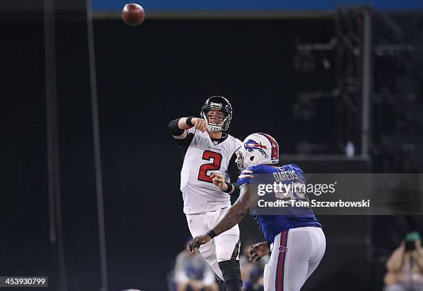 Matt Ryan of the Atlanta Falcons completes a pass to Roddy White during an NFL game under pressure from Marcell Dareus of the Buffalo Bills at Rogers...