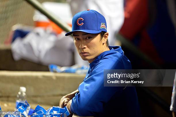 Tsuyoshi Wada of the Chicago Cubs stands in the dugout during the sixth inning against the San Francisco Giants at Wrigley Field on August 21, 2014...