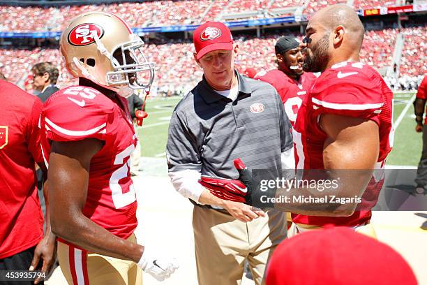 Linebackers Coach Jim Leavitt of the San Francisco 49ers talks with Jimmie Ward and Michael Wilhoite during the game against the Denver Broncos at...