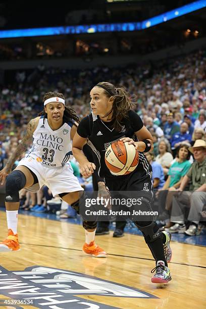 Becky Hammon of the San Antonio Stars drives to the basket against Seimone Augustus of the Minnesota Lynx in Game One of the Western Conference...