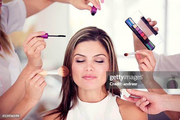 woman getting her makeup done - make over series stock pictures, royalty-free photos & images