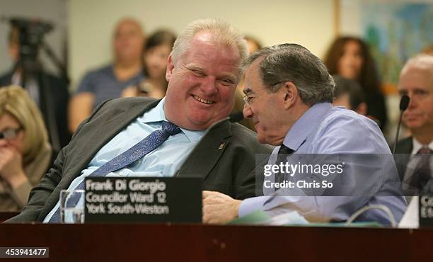 Mayor Rob Ford at council meeting shares a light moment with Councillor Frank Di Giorgio. December 5, 2013.