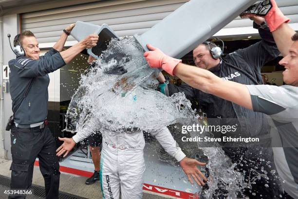 Lewis Hamilton of Great Britain and Mercedes GP takes part in an ice bucket challenge outside the team garage during practice ahead of the Belgian...