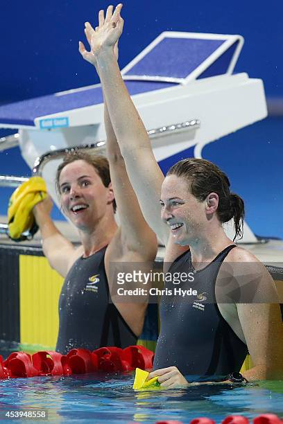 Cate Campbell and Bronte Campbell celebrate after coming first and second in the Women's 100m Freestyle final during day two of the 2014 Pan Pacific...
