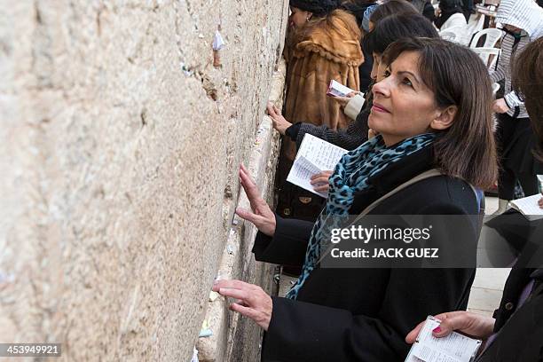 Anne Hidalgo, Paris deputy mayor and Socialist Party candidate for the primary round of Paris municipal elections, puts a paper with wishes in a...