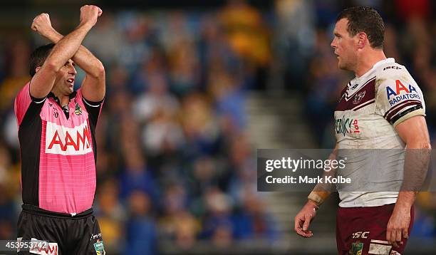 Referee Alan Shortall places Jason King of the Sea Eagles on report for a high tackle on Tepai Moeroa of the Eels during the round 24 NRL match...