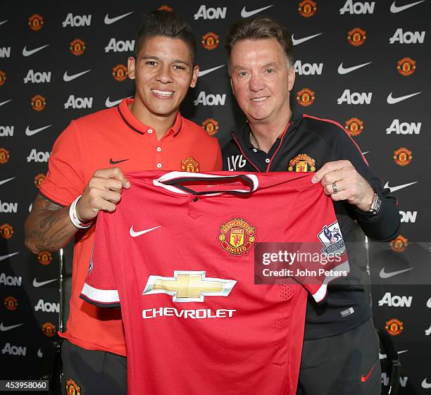 Manager Louis van Gaal of Manchester United poses with new signing Marcos Rojo after a press conference at Aon Training Complex on August 22, 2014 in...