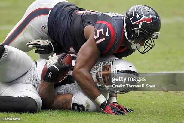 Darryl Sharpton of the Houston Texans tackles Juron Criner of the Oakland Raiders on November 17, 2013 at Reliant Stadium in Houston, Texas. Raiders...