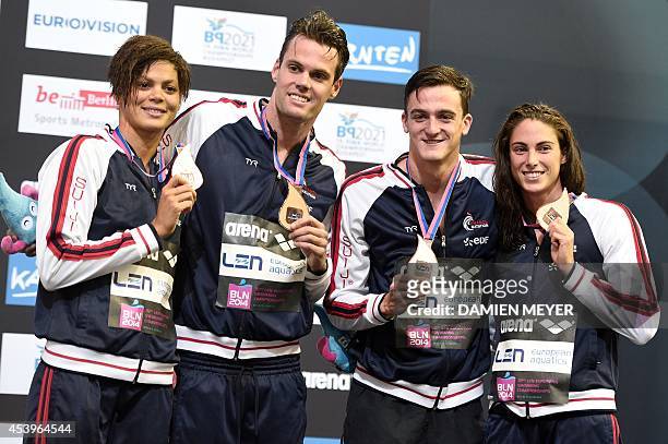 France's team Coralie Balmy, Gregory Mallet, Clement Mignon and Anna Santamans celebrate winning bronze on the podium after the mixed 4x100m...