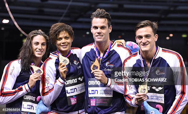 France's team Anna Santamans, Coralie Balmy, Clement Mignon and Gregory Mallet celebrate winning bronze on the podium after the mixed 4x100m...