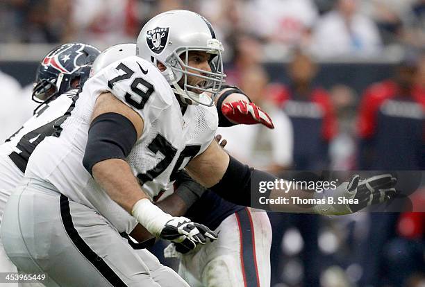 Tony Pashos of the Oakland Raiders blocks J.J. Watt of the Houston Texans on November 17, 2013 at Reliant Stadium in Houston, Texas. Raiders won 28...