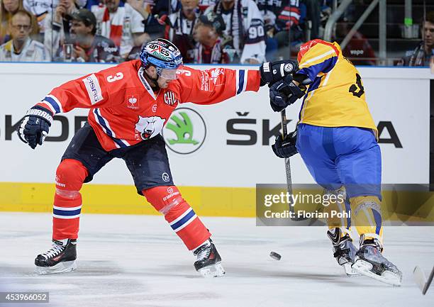 Jimmy Sharrow of Eisbären Berlin and Bedrich Koehler of PSG Zlin struggles for the puck during the Champions Hockey League group stage game between...