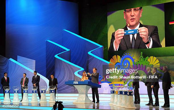 Secretary General Jerome Valcke holds up the name of Germany during the Final Draw for the 2014 FIFA World Cup Brazil at Costa do Sauipe Resort on...