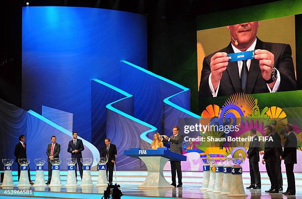 Secretary General Jerome Valcke holds up the name of Japan during the Final Draw for the 2014 FIFA World Cup Brazil at Costa do Sauipe Resort on...