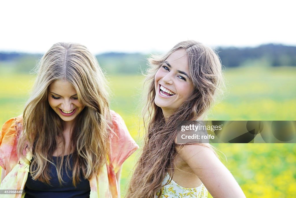 Two beautiful young woman laughing