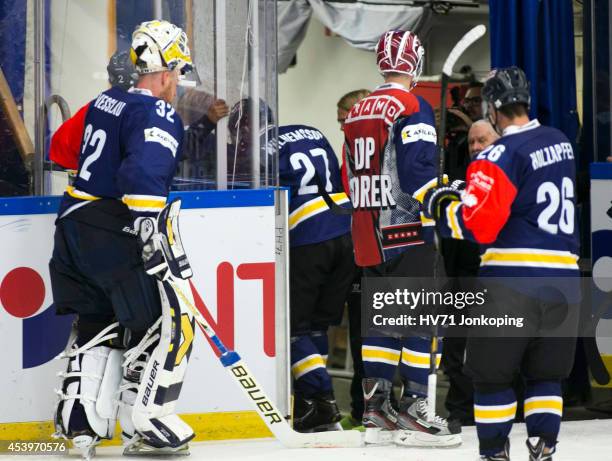 Jesper Williamsson of HV71 is helped off the ice after a highsticking by Victor Stancescu of Kloten Flyers during the Champions Hockey League group...